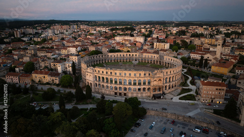 Flying above historic city of Pula , historic Roman amphitheatre of Pula aerial view, tourism in Croatia