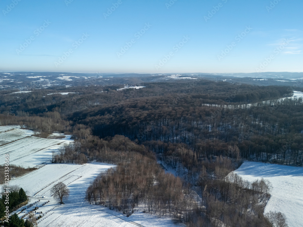 Aerial view of snowy landscapes under a clear blue sky showcasing vast fields and wooded areas. Perfect for nature and winter themes. Aerial view of snowy landscapes under a clear blue sky showcasing vast fields and wooded areas. Perfect for nature and winter themes.