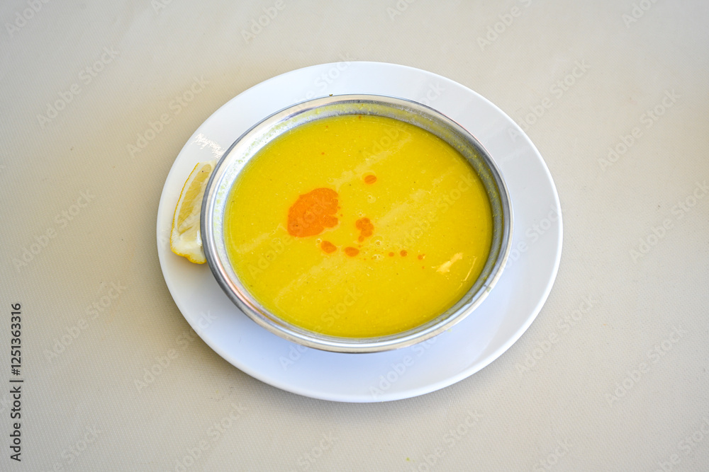 Lentil ( mercimek corbasi ) soup with melted butter and red pepper sauce. Limon ve soslu mercimek corba. Lentil ( mercimek corbasi ) soup with melted butter and red pepper sauce. Limon ve soslu mercimek corba.