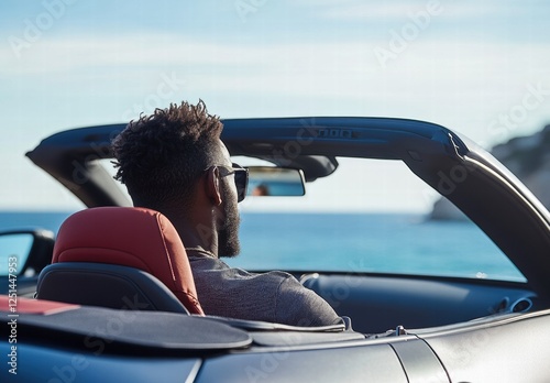 Wallpaper Mural A man in a black shirt is driving a convertible car with the top down Torontodigital.ca