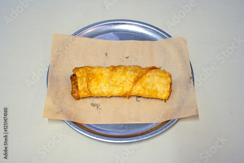 Turkish style meat stuffed filo dough borek served kol boregi. Cheese and minced pie are sliced on a marble background.  Avci boregi.Turkish name: Kol Boregi. Kiymali, peynirli su boregi. photo