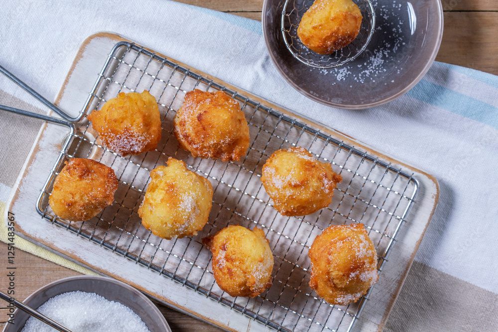 Curd donuts with sugar served with tea or coffee on a light wooden background. Rustic style.