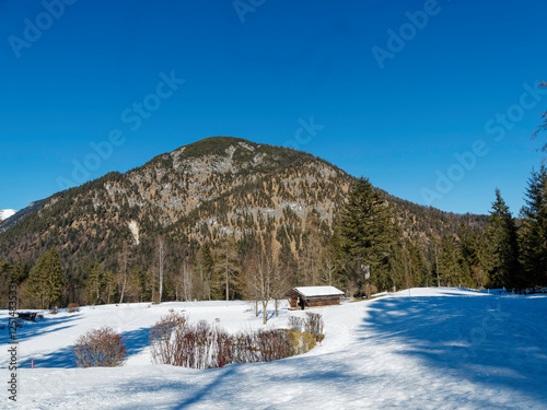 Pertisau am Achensee  on the Karwendel nature reserve. Snowy landscape around Tristenau trail with Limestone cliffs droping abruptly in wooded valleys photo