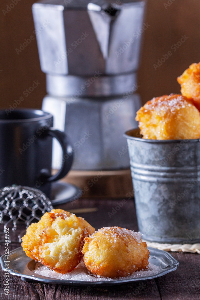 Curd donuts with sugar served with tea or coffee on a light wooden background. Rustic style.