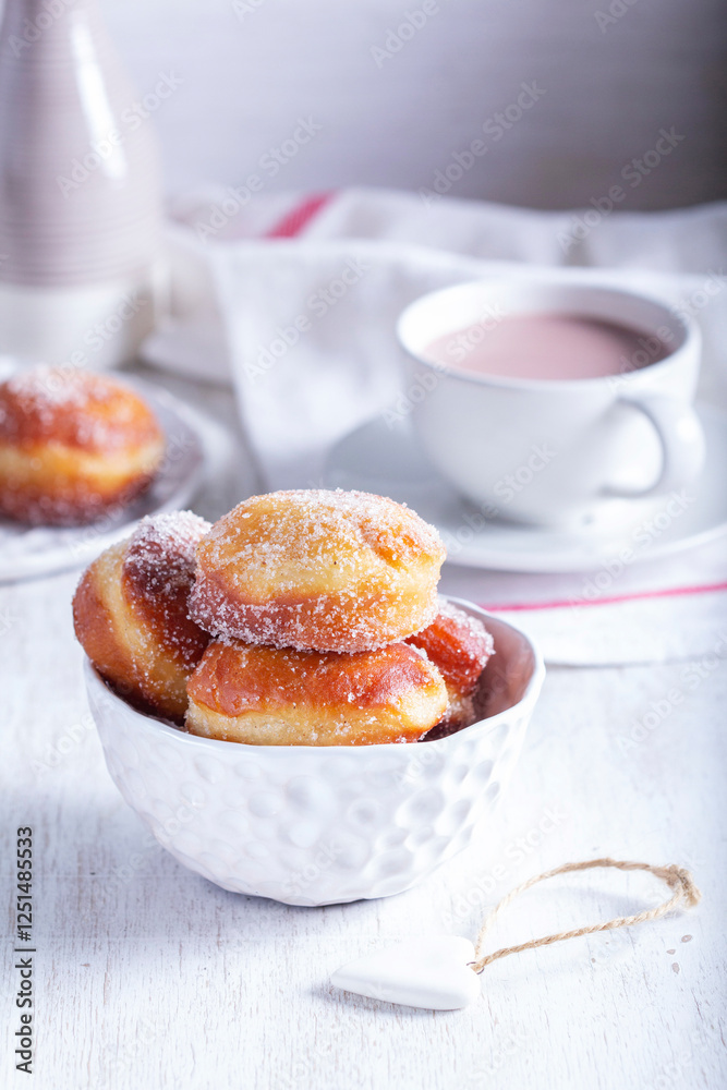 Donuts with sugar and cinnamon served with cocoa. Traditional dessert for Carnival.
