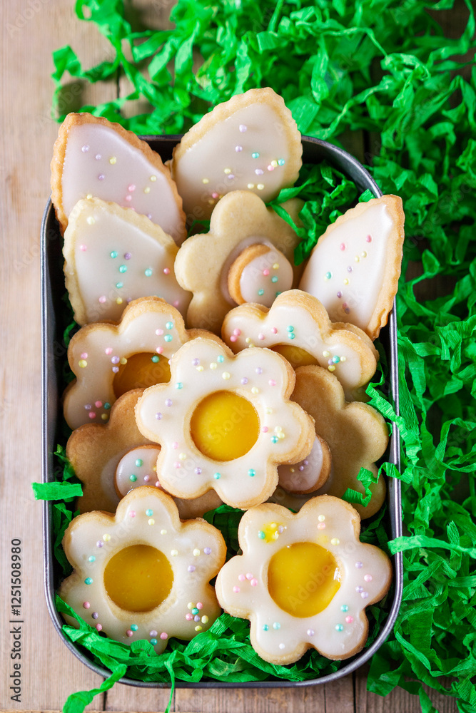 Shortbread cookies with lemon filling in the shape of butterflies, flowers and leaves.