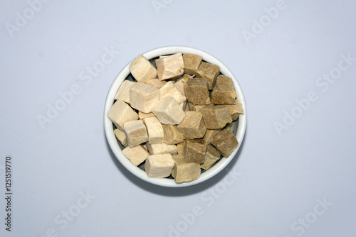 a bowl of freeze dried chicken breast and duck in cube for cat and dog