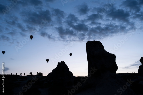 Hot air balloon is on the air at Cappadocia. Silhouette photo at sunrise.