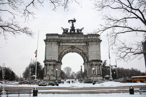 grand army plaza arch view covered in snow during winter at entrance to prospect park in brooklyn new york city (famous landmark during snowstorm blizzard) beautiful wintry cityscape flatbush union st photo