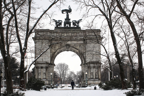grand army plaza arch view covered in snow during winter at entrance to prospect park in brooklyn new york city (famous landmark during snowstorm blizzard) beautiful wintry cityscape flatbush union st photo