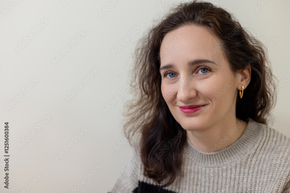 Woman smiling in a closeup portrait with a neutral background, A closeup portrait of a smiling woman with a neutral light background. Space for text. Woman smiling in a closeup portrait with a neutral background, A closeup portrait of a smiling woman with a neutral light background. Space for text.