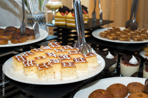 Party reception. Dessert buffet. A table filled with assortment of deserts. Catering for an event.
