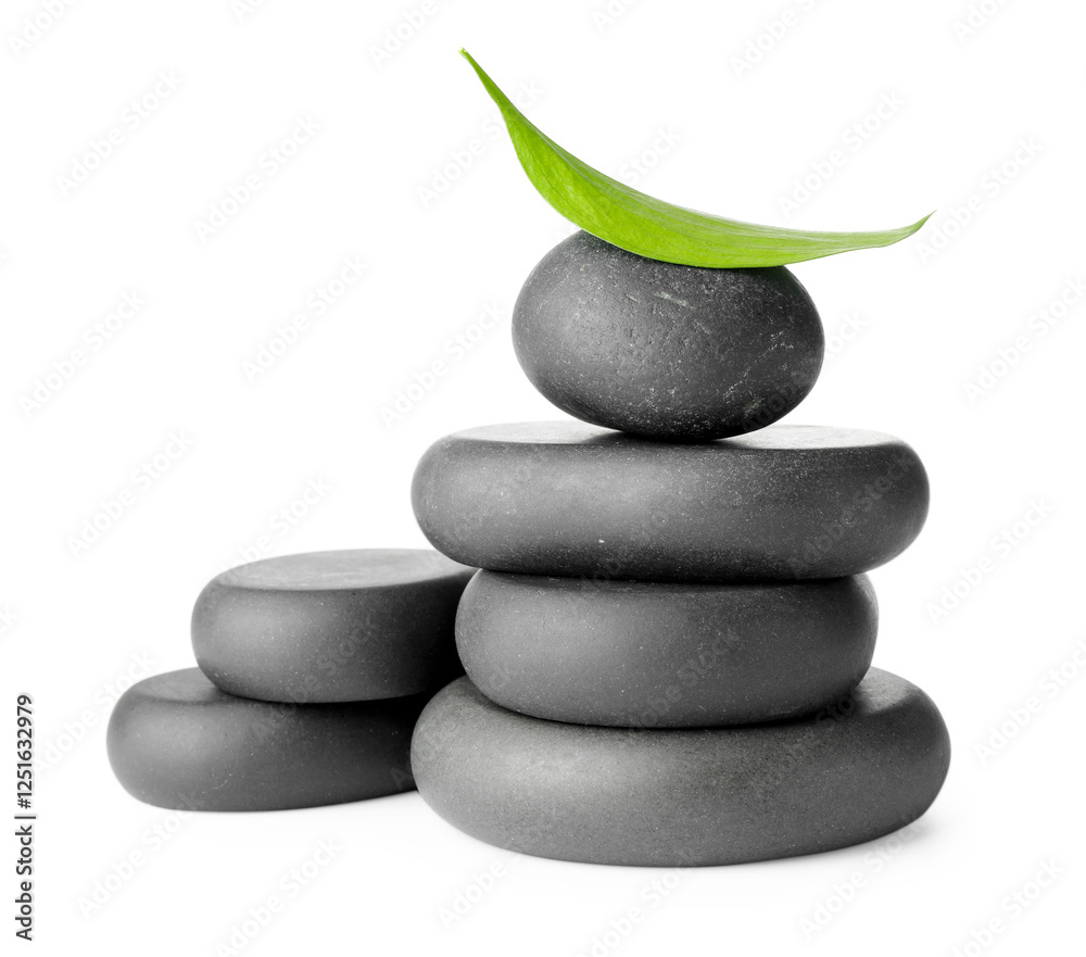 Stacked spa stones and green leaf isolated on white Stacked spa stones and green leaf isolated on white