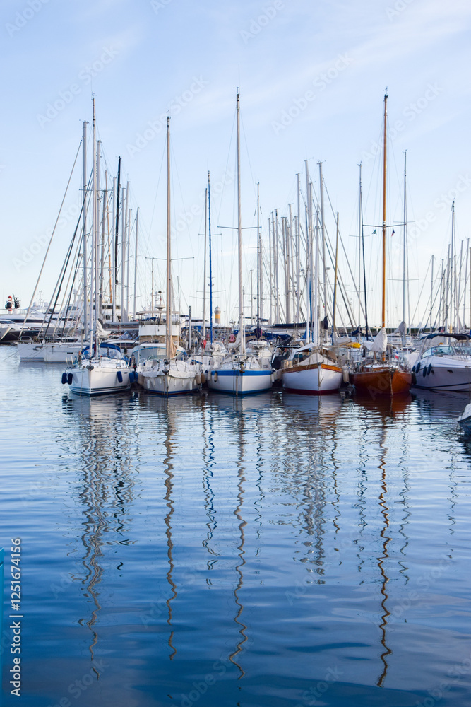 Reflection of sailboats moored in a marina Reflection of sailboats moored in a marina