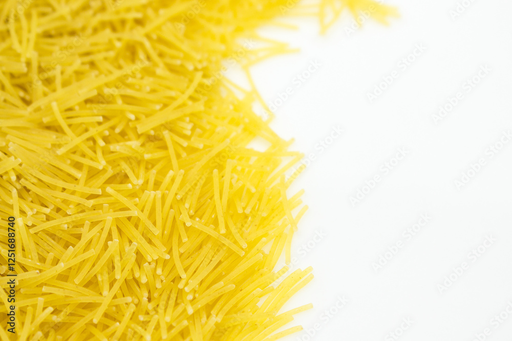 Obraz premium Uncooked vermicelli Pasta with Copy Space on White Background. Raw and Dry vermicelli.