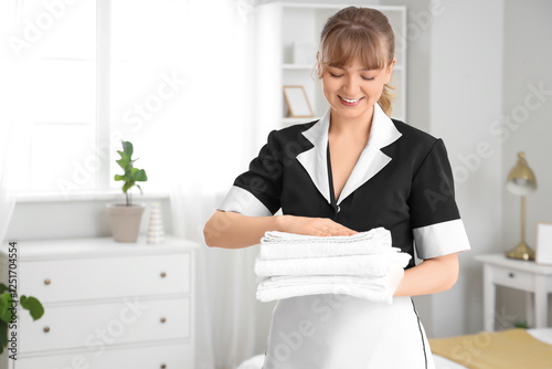 Smiling young chambermaid h...