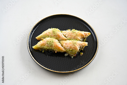 Turkish Dessert Sobiyet, havuc dilimi, midye baklava, mussels baklava and classic baklava with Pistachio . Cikoltali cevizli, fistikli soguk Baklava, top view. photo