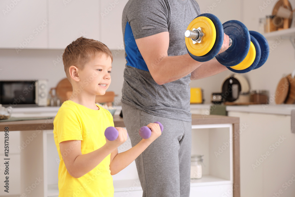 Young man and his little son training with dumbbells at home Young man and his little son training with dumbbells at home