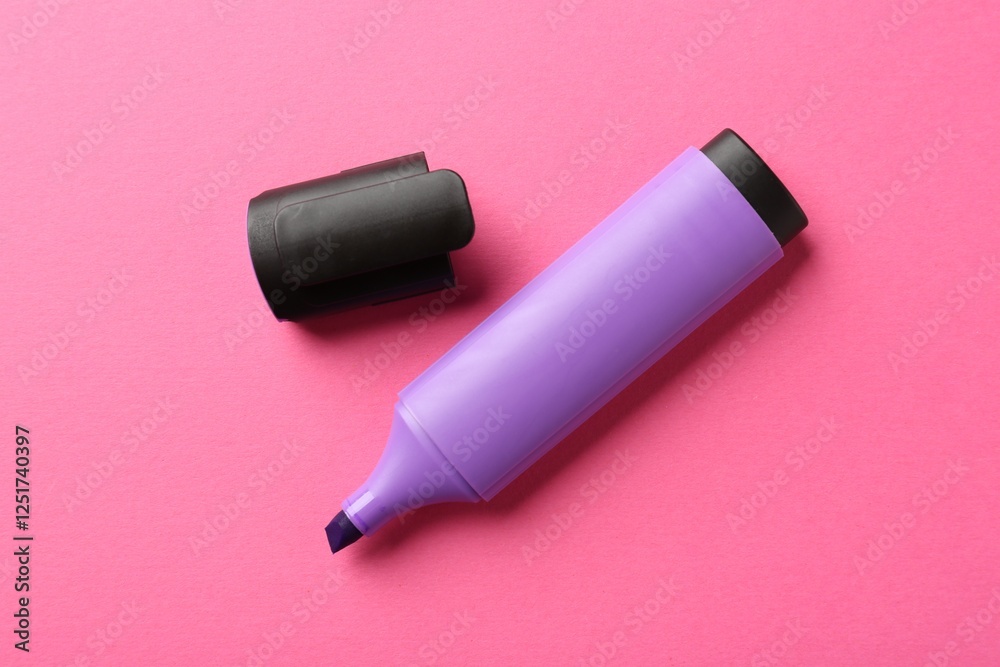 Bright highlighter and cap on pink background, flat lay Bright highlighter and cap on pink background, flat lay