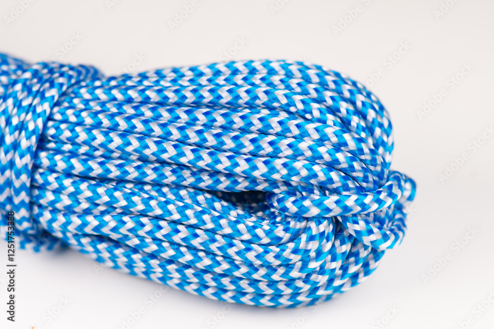 Blue rope made of synthetic polyester material for climbing. Close-up background. Blue rope made of synthetic polyester material for climbing. Close-up background.