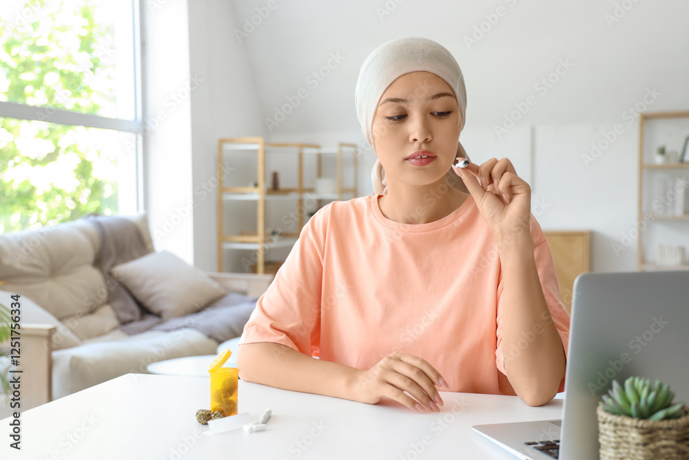 Young Asian woman after chemotherapy smoking weed at home Young Asian woman after chemotherapy smoking weed at home