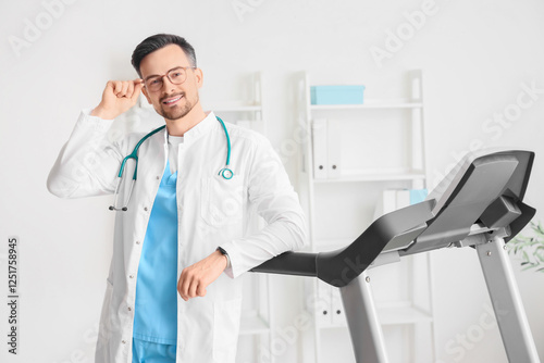 Male doctor near treadmill ...