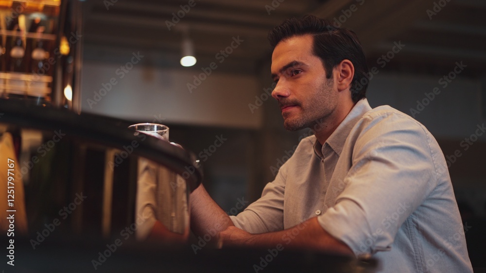 Sitting smart man drinking alone of cocktail Old fashioned waiting friends or couple at bokeh lighting at luxurious beverage counter nightclub at pub and restaurant on Friday meeting night. Vinosity. Sitting smart man drinking alone of cocktail Old fashioned waiting friends or couple at bokeh lighting at luxurious beverage counter nightclub at pub and restaurant on Friday meeting night. Vinosity.