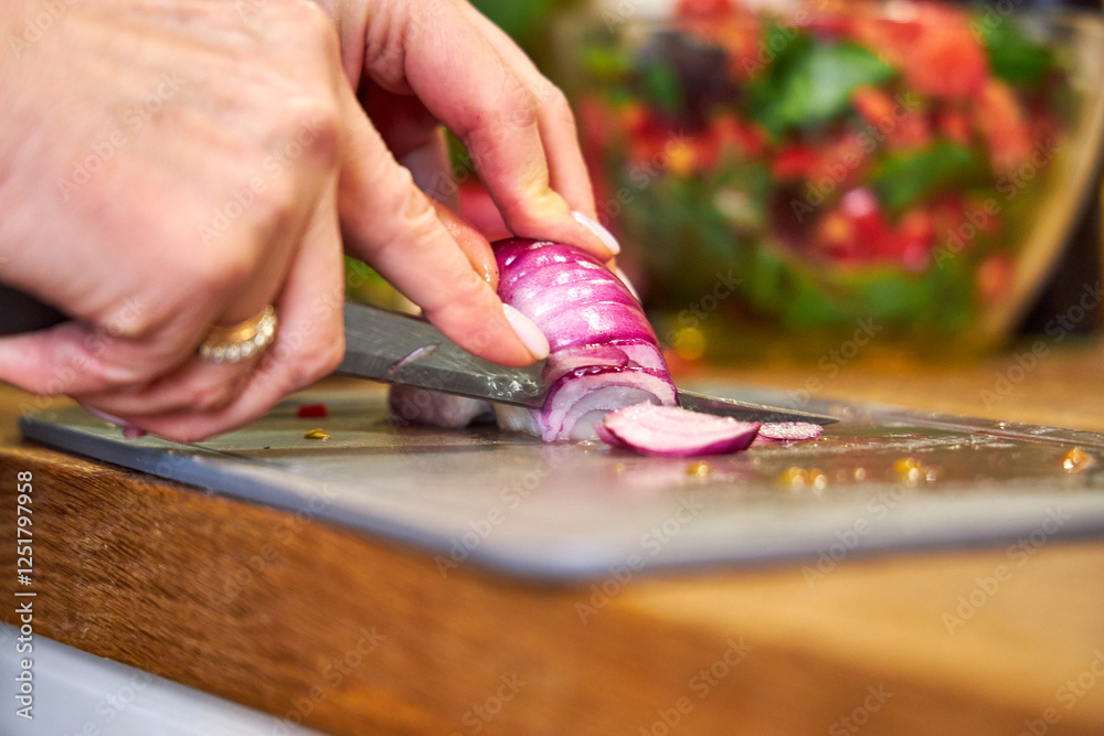 a woman cutting red onions for salad, top view, close-up a woman cutting red onions for salad, top view, close-up