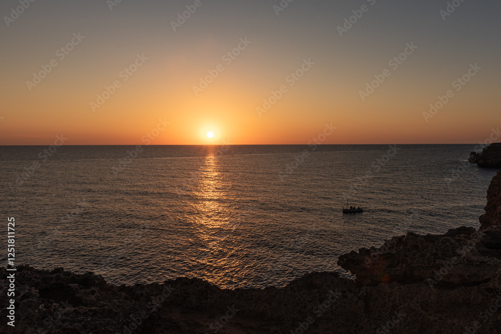 A boat serenely sailing on calm waters at dawn or dusk. A boat serenely sailing on calm waters at dawn or dusk.