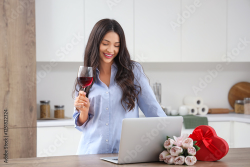 Young woman drinking wine a...