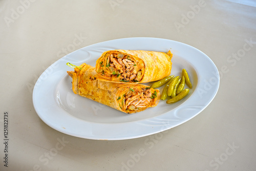 Lavash doner kebab ( soslu kasarli zurna doner durum )  or shawarma sliced in plate isolated.  Tavuk Et Doner Durum. Hatay Iskenderun usulu bazuka tavuk doner durum.  photo