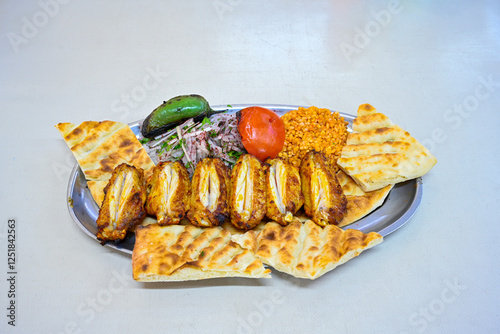 Chicken wings barbeque in a dish with BBQ grill sauce . Izgara tavuk kelebek sis kanat. Izgara tavuk sis, gogus.