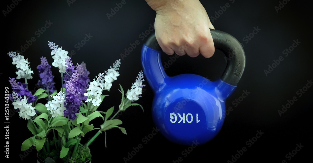 Hand lifting kettlebell next to lavender flowers
