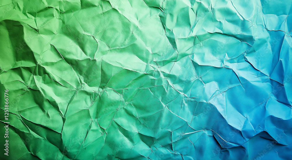 Fototapeta premium A close-up of crumpled green and blue foil, creating a textured background. The wrinkles and folds of the foil add depth and interest, making it visually striking with a unique, vibrant appearance