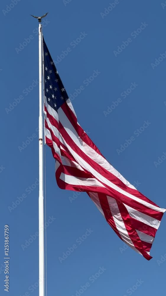 The US flag waving under the sun