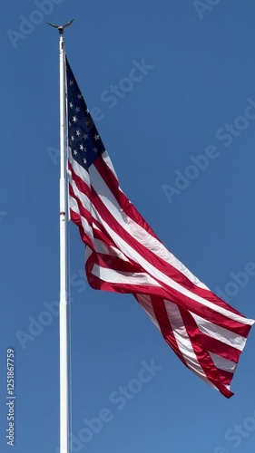 The US flag waving under the sun