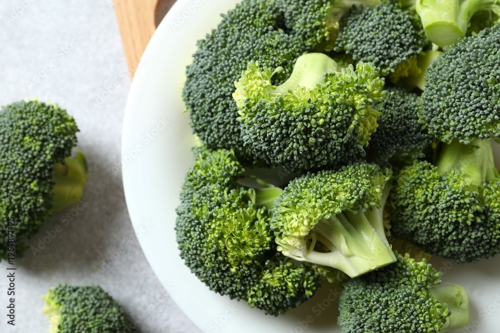 Fresh green broccoli in a plate on gray table Fresh green broccoli in a plate on gray table