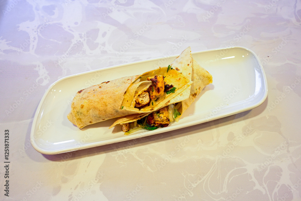 Lavash doner kebab ( soslu kasarli zurna doner durum ) or shawarma sliced in plate isolated. Tavuk Et Doner Durum. Hatay Iskenderun usulu bazuka tavuk doner durum. Lavash doner kebab ( soslu kasarli zurna doner durum ) or shawarma sliced in plate isolated. Tavuk Et Doner Durum. Hatay Iskenderun usulu bazuka tavuk doner durum.