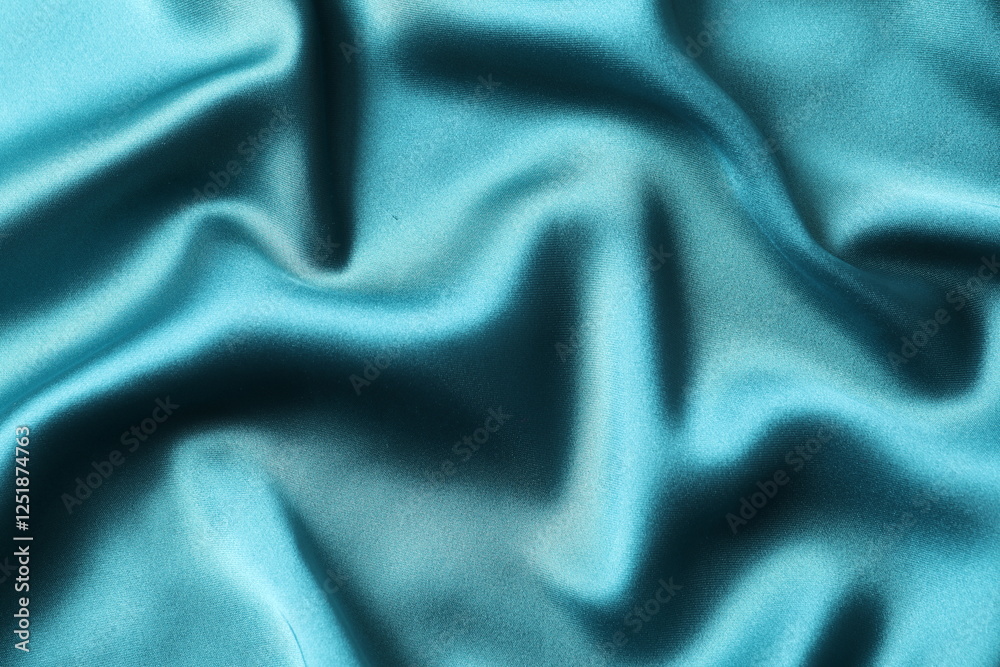 Silk satin dark turquoise color. Shiny smooth fabric. Soft folds. Luxury background with space for design. Flat table, top view Silk satin dark turquoise color. Shiny smooth fabric. Soft folds. Luxury background with space for design. Flat table, top view