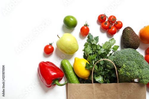 Fototapeta Naklejka Na Ścianę i Meble -  Paper bag, vegetables and fruits on color background