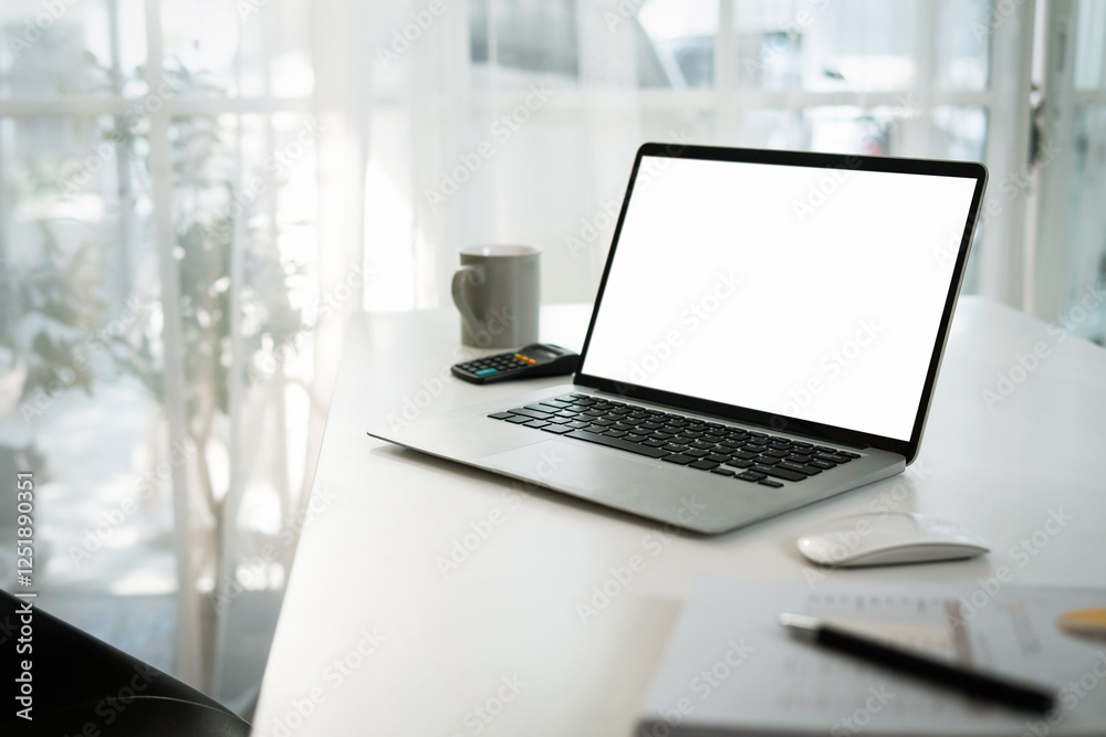 Fototapeta premium White screen laptop mockup Place a work desk next to the window.