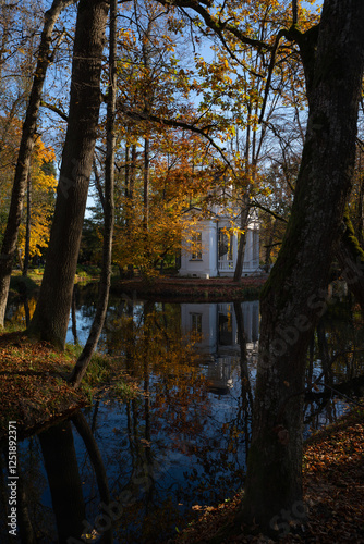 Autumn surrounds the white park house.