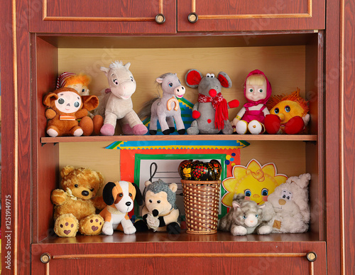 A shelf full of stuffed animals including teddy bears, cats, dogs, and a horse