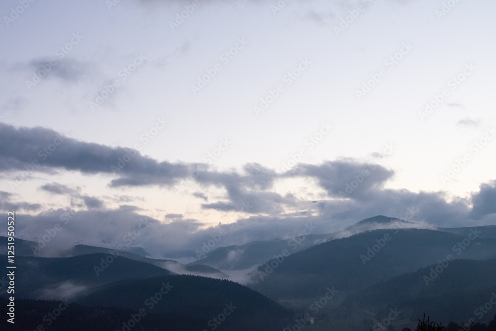 Fototapeta premium Clouds coming in over the rocky mountains