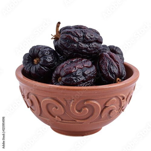 Closeup of a brown clay bowl filled with dark, shiny dried prunes against a cutout background. photo