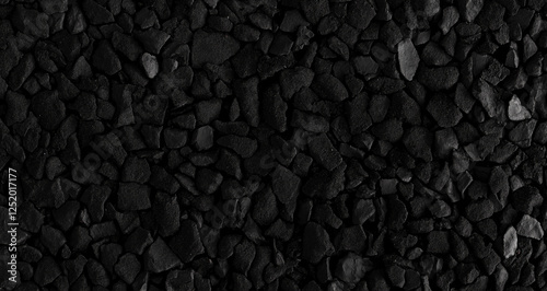 A black asphalt background with a top-down view of a smooth road texture, showcasing grainy particles. The high-quality image features ample copy space, making it perfect for various design applicatio photo