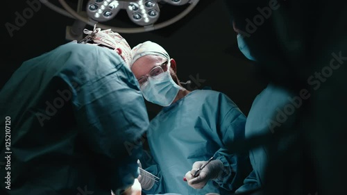 A team of professional surgeons performs surgery in a modern hospital. Concept: skills working using the latest technology in cardiology and transplantation.