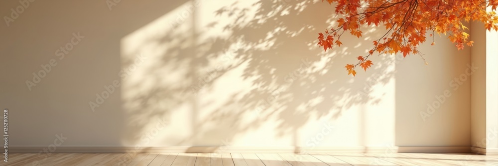 Orange maple leaves cast shadows on wall in sunlit room. Fall nature background with copy space. Sunlight interior. Minimalist tranquil season decor. Autumn gold shades scene. Orange maple leaves cast shadows on wall in sunlit room. Fall nature background with copy space. Sunlight interior. Minimalist tranquil season decor. Autumn gold shades scene.