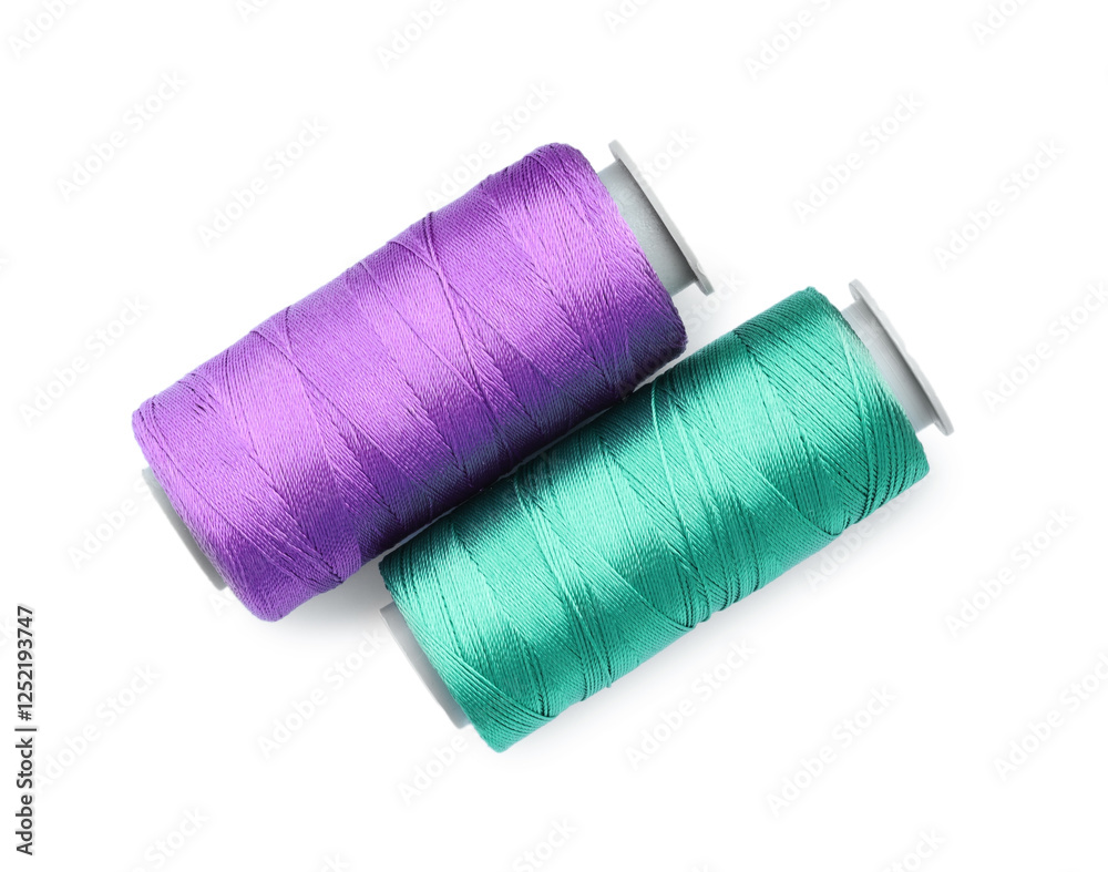 Spools of bright sewing threads isolated on white, top view Spools of bright sewing threads isolated on white, top view
