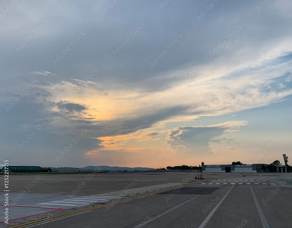 Fototapeta premium sunset on the runway, clouds